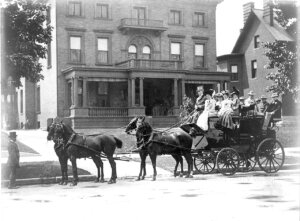 Samuel Culbertson, 5th president of Churchill Downs, prepares to attend the Kentucky Derby with guests. The horse drawn carriage sits outside his residence at 1432 S. 3rd Street in Louisville, Kentucky. (Photo courtesy of Kentucky Derby Museum/Churchill Downs)