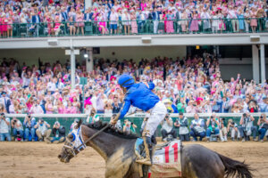Good Cheer with jockey Luis Saez up rides by the crowds in the grandstands after winning the Kentucky Oaks race.