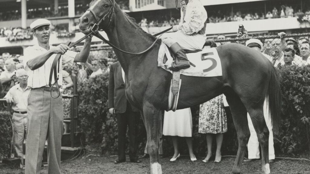 Sword Dancer, Bill Shoemaker up, in winner's circle after Monmouth Handicap.