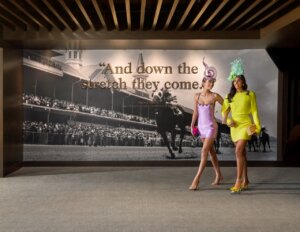 Women wearing bright spring dresses and statement hats at the Kentucky Derby 2026