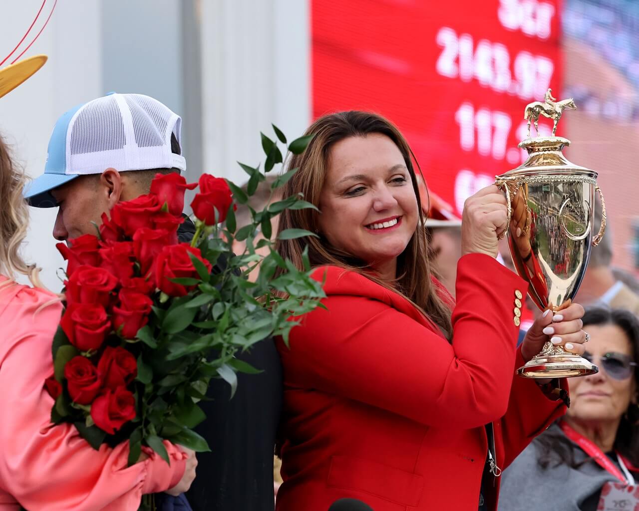 Cherie DeVaux hoists the Kentucky Derby trophy (Photo by Coady Media)